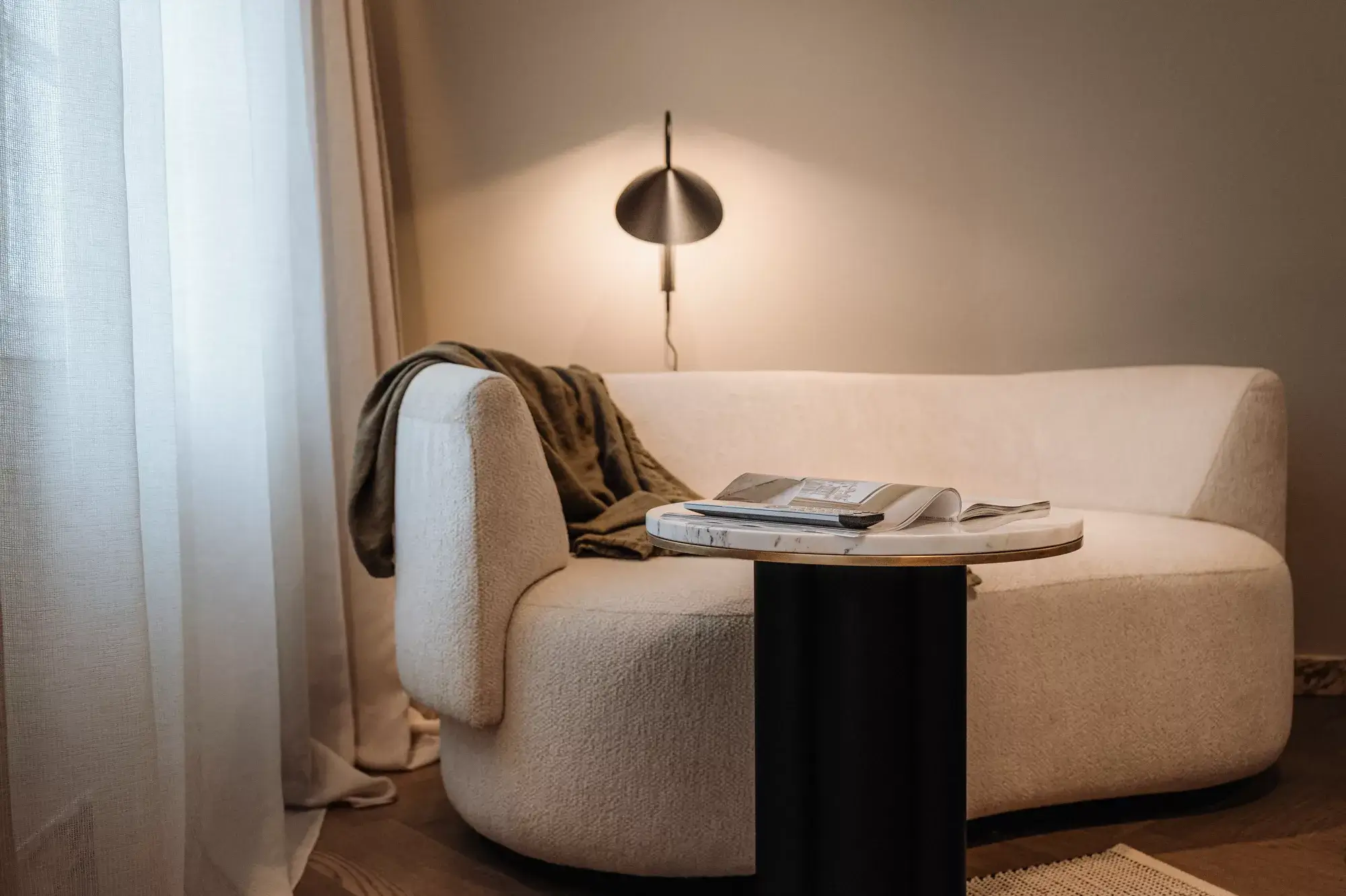 A detailed shot of a cozy sofa in one of the Gentle Hide rooms, showcasing soft cushions and warm lighting.